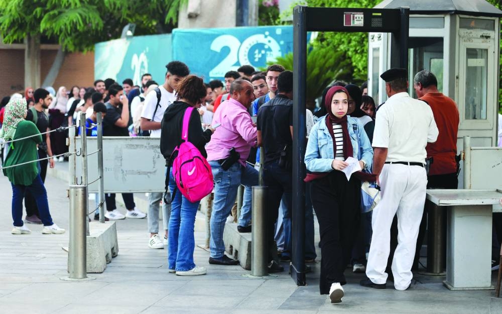 
Students queue to study for their high school certificate exams at the Bibliotheca Alexandrina library and cultural centre as Egyptians experience frequent power cuts. 