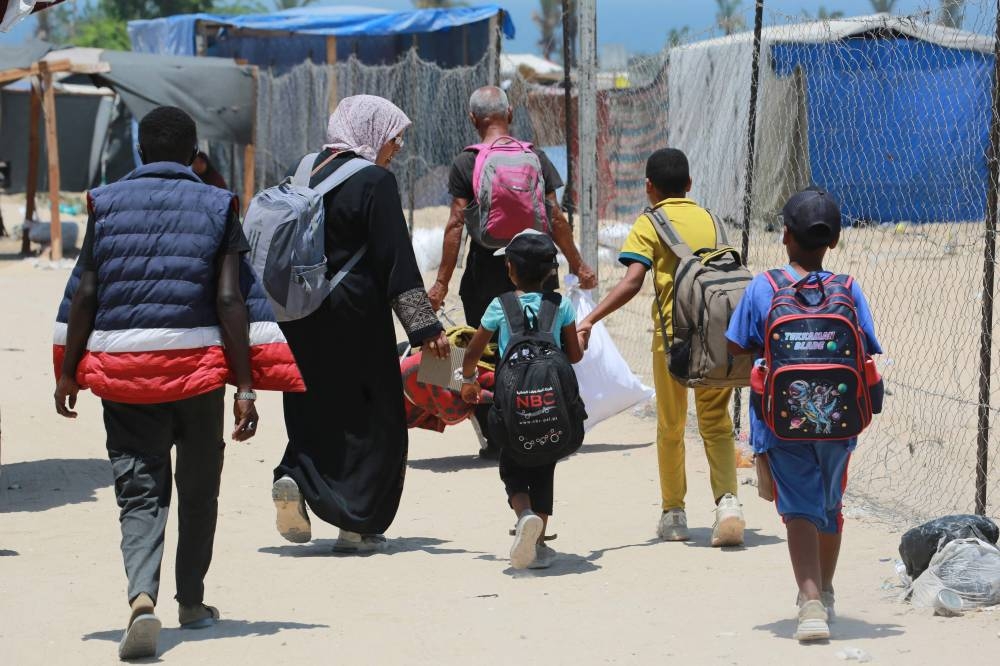 Displaced Palestinians evacuate the Mawassi area on the outskirts of southwestern Khan Yunis in the southern Gaza Strip on Friday. AFP