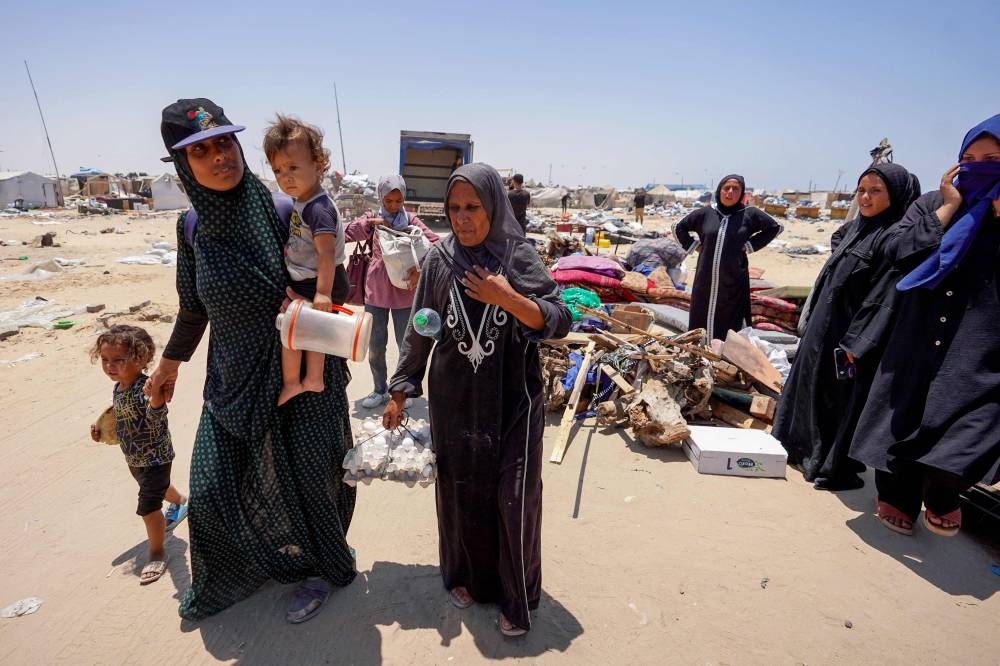 Displaced Palestinians evacuate the Mawassi area on the outskirts of southwestern Khan Yunis in the southern Gaza Strip on Friday. AFP