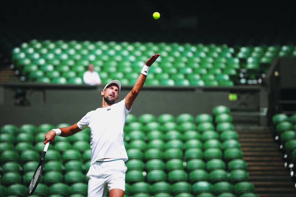 
Serbia’s Novak Djokovic attends a warm up session on centre court at the All England Lawn Tennis Club in west London. (AFP) 