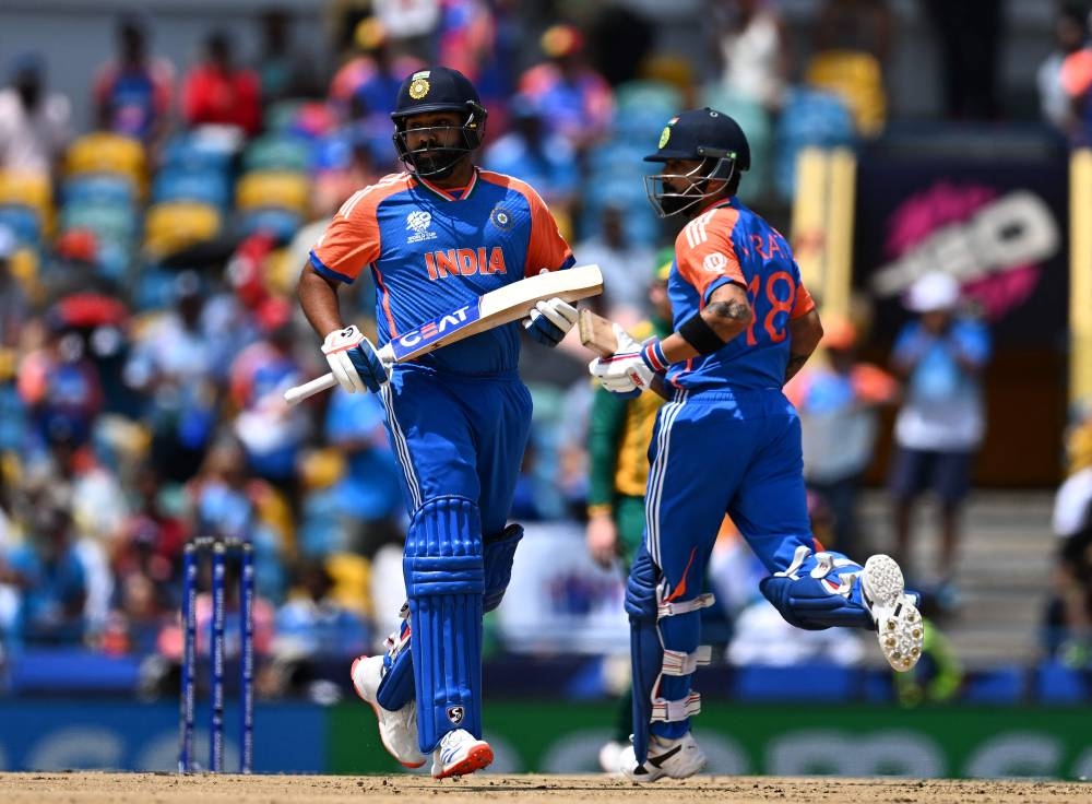 India's Virat Kohli (R)and India's captain Rohit Sharma run between the wickets during the ICC men's Twenty20 World Cup 2024 final cricket match between India and South Africa at Kensington Oval in Bridgetown, Barbados. AFP