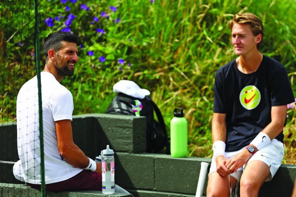 
Serbia’s Novak Djokovic (left) and Sebastian Korda of the US during a practice session ahead of the Wimbledon which starts today. (Reuters) 