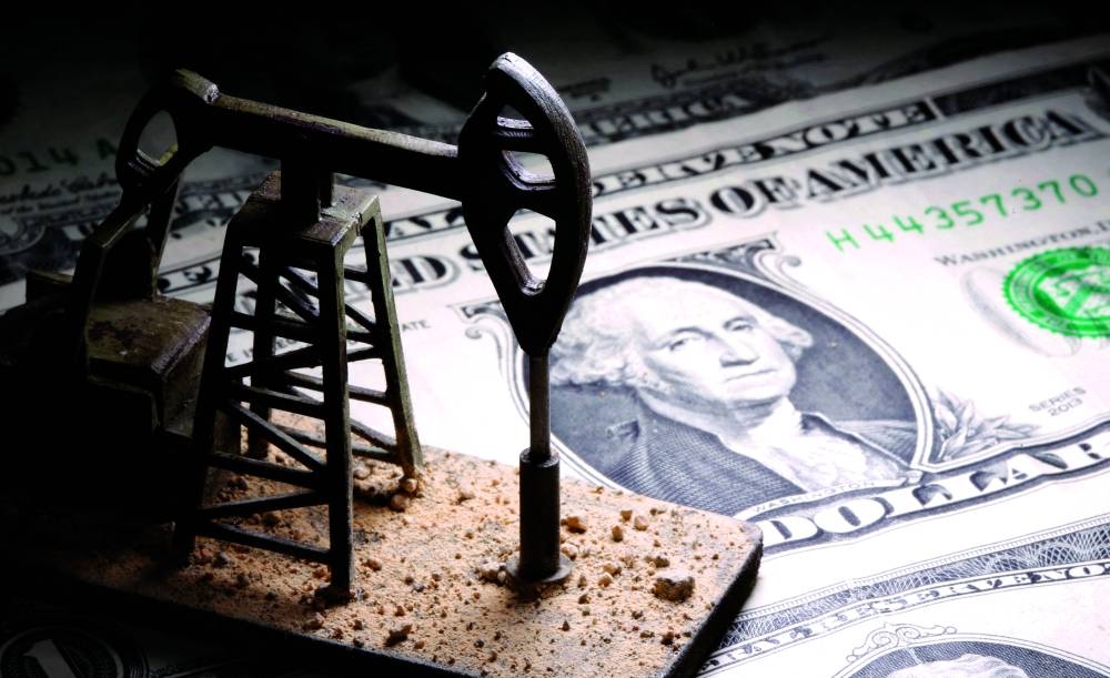 FILE PHOTO: A 3D-printed oil pump jack is placed on dollar banknotes in this illustration picture, April 14, 2020. REUTERS/Dado Ruvic/Illustration/