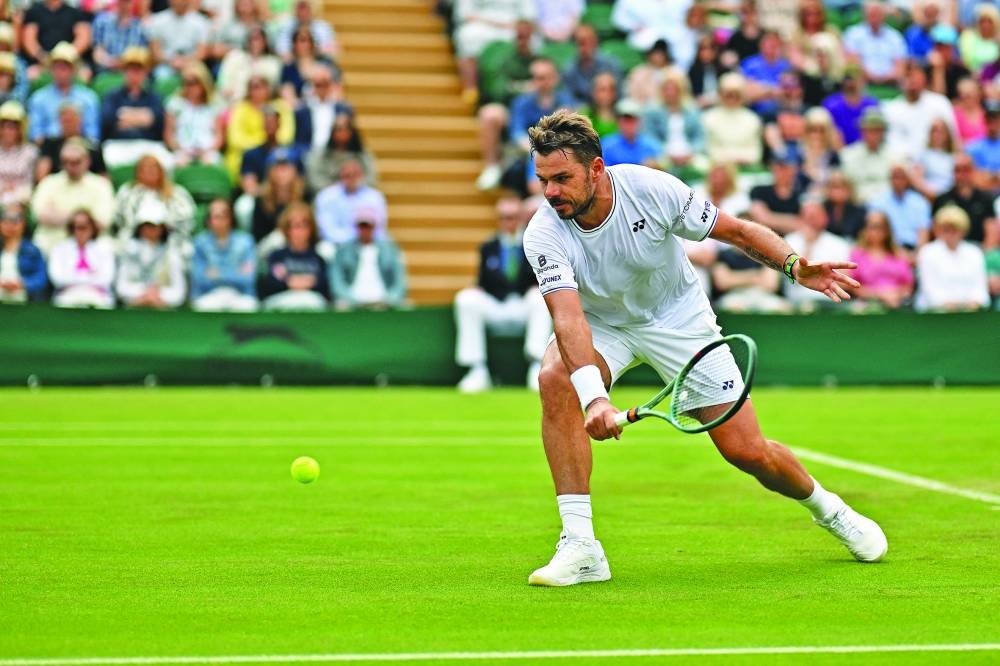 Switzerland's Stan Wawrinka returns against Britain's Charles Broom during their singles match on the first day of the 2024 Wimbledon Championships at The All England Lawn Tennis and Croquet Club in Wimbledon, southwest London, on Monday. (AFP)