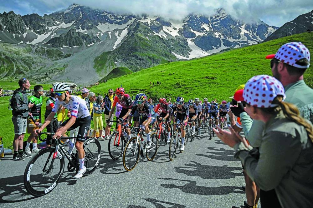 UAE Team Emirates’ Slovenian rider Tadej Pogacar (left) and Red Bull - BORA - hansgrohe team’s Slovenian rider Primoz Roglic (second left) cycle with the pack of riders (peloton) in the Galibier ascent during the 4th stage of the 111th edition of the Tour de France cycling race, 140km between Pinerolo in Italy, and Valloire in France, yesterday. (AFP) 