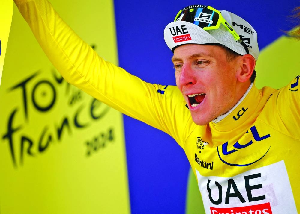 Pogacar celebrates on the podium after the fourth stage. (Reuters)