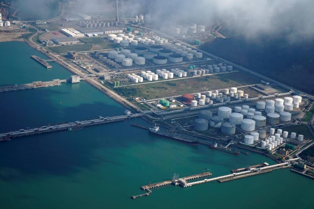 Oil and gas tanks are seen at an oil warehouse at a port in Zhuhai, China. The global oil market faces soft spots in the outlook for Chinese demand this half, potentially adding a headwind for crude prices.