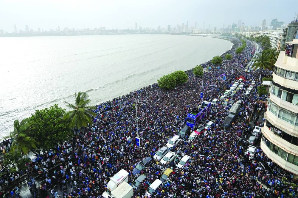 Fans wait for the arrival of Indian cricket team members for a victory parade to celebrate winning the ICC men's T20 World Cup, along the Marine Drive in Mumbai on Thursday. (Reuters)