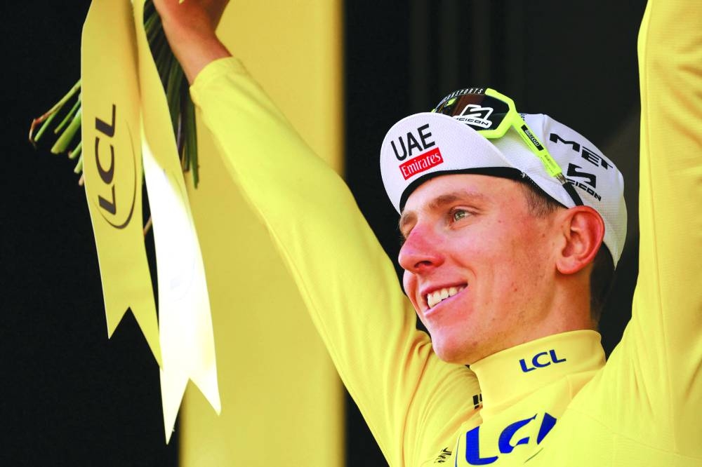 
UAE Team Emirates’ Slovenian rider Tadej Pogacar celebrates on the podium. (Reuters) 