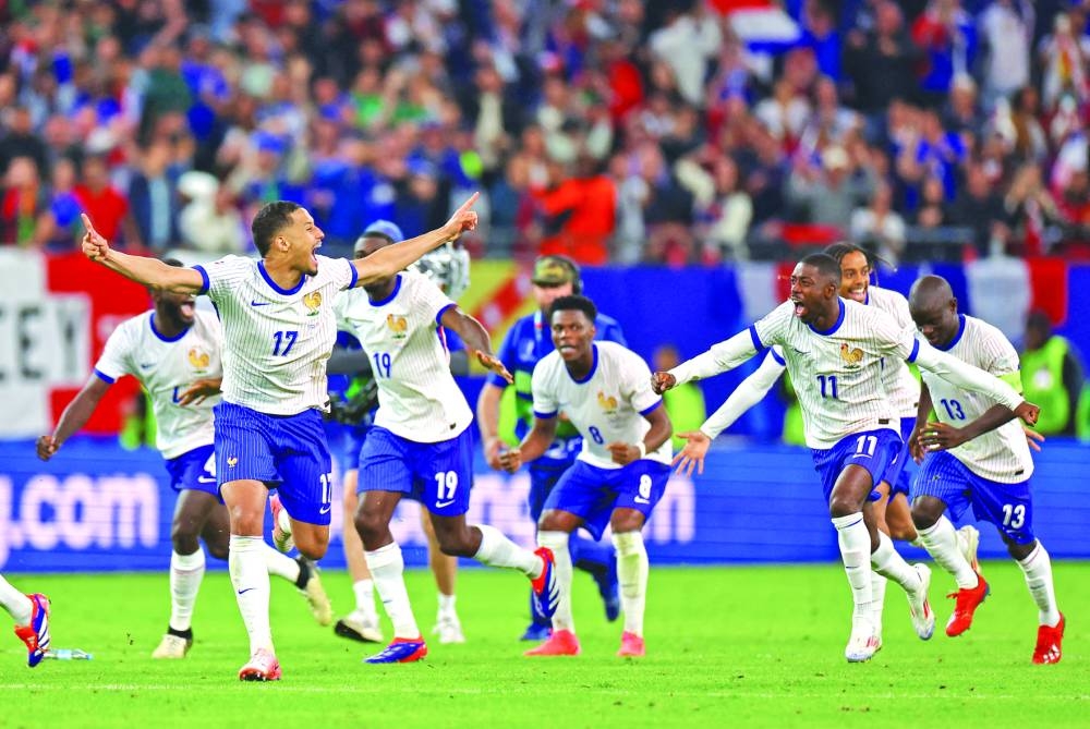 France players celebrate after winning the penalty shootout against Portugal in their Euro 2024 quarter-final in Hamburg on Friday. (Reuters)