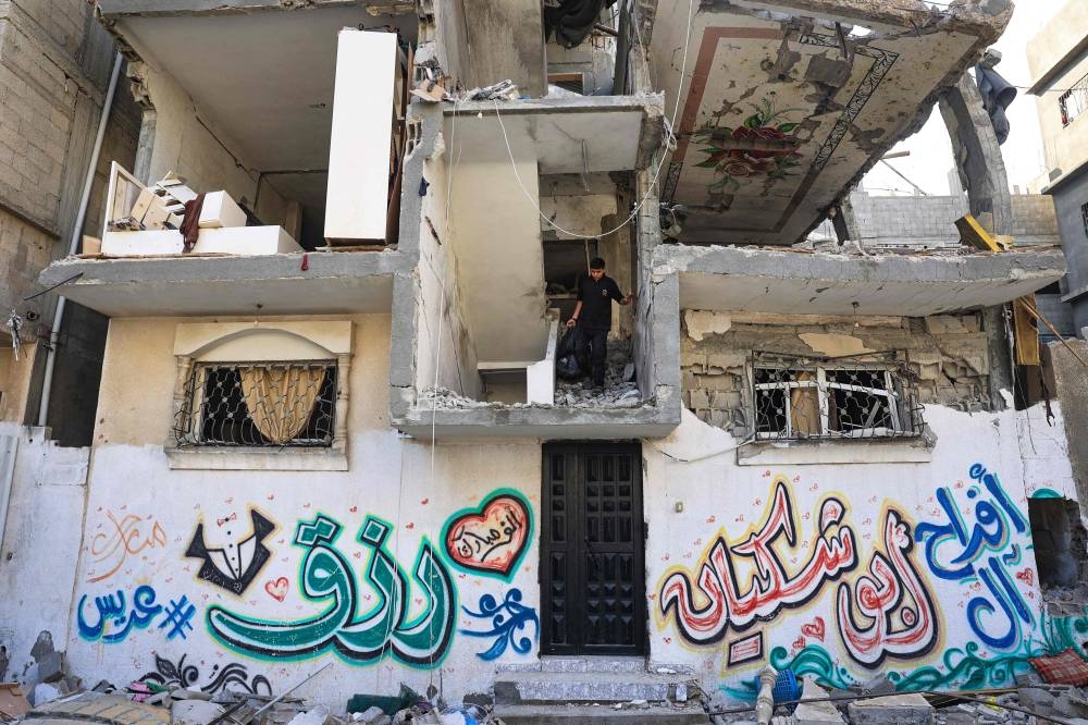 Palestinians asses the damage following an Israeli strike in the Nuseirat refugee camp in the central Gaza Strip on Saturday. AFP