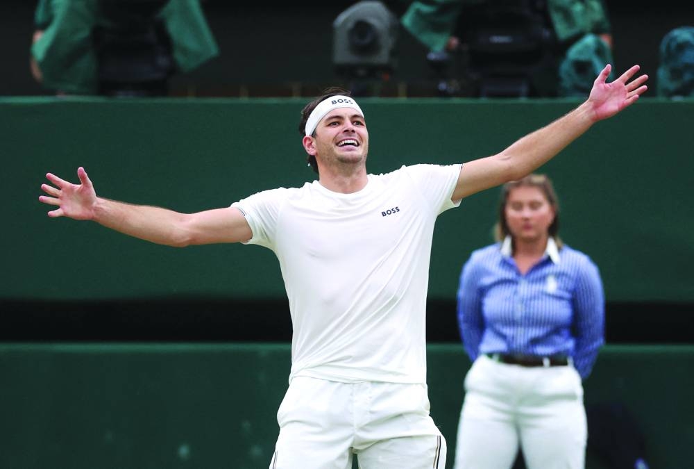 Taylor Fritz of the US celebrates after winning his fourth-round match against Germany’s Alexander Zverev on Monday. (Reuters)