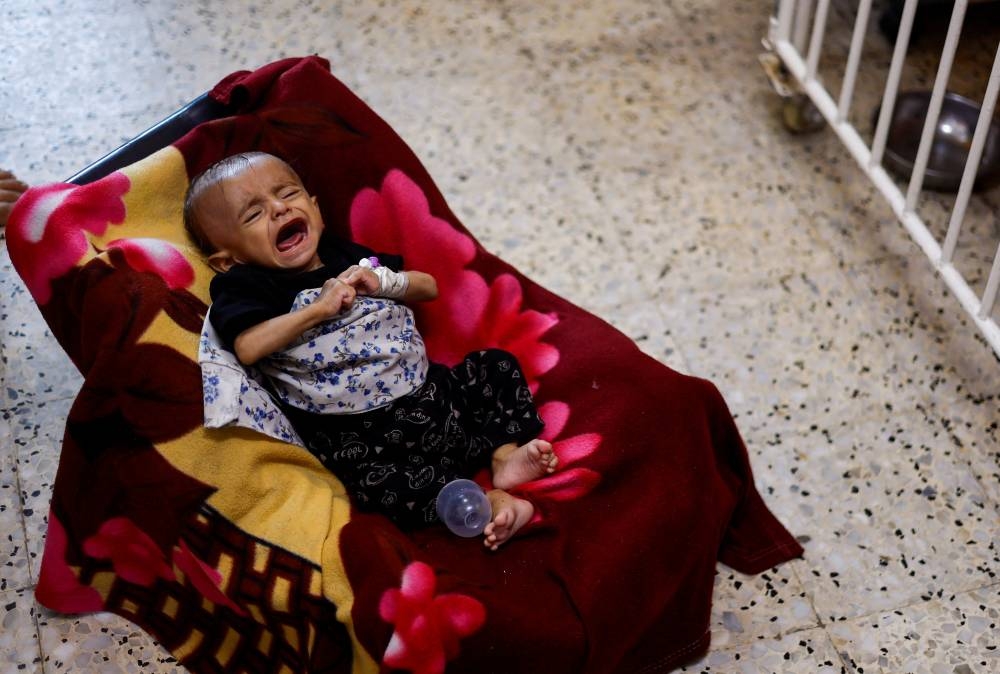 A Palestinian child cries as patients are treated in the corridors at Nasser hospital, in Khan Younis, in the southern Gaza Strip, Monday. REUTERS