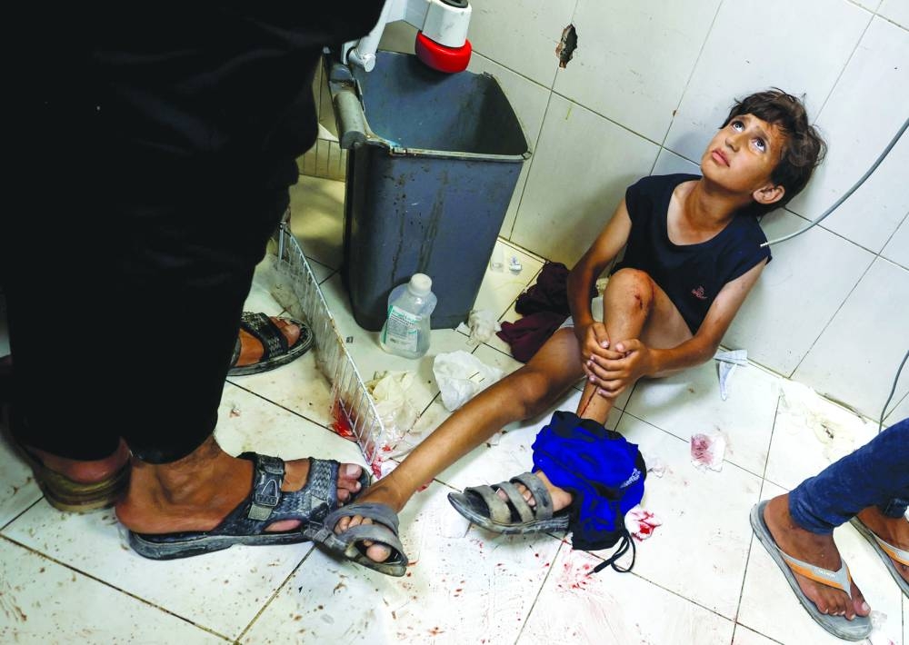 A Palestinian boy looks on at Nasser hospital, following an Israeli strike in Khan Younis, in the southern Gaza Strip, Tuesday.