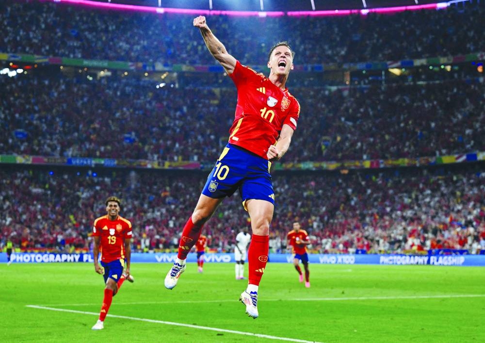Spain’s Dani Olmo celebrates their second goal on Tuesday. (Reuters)