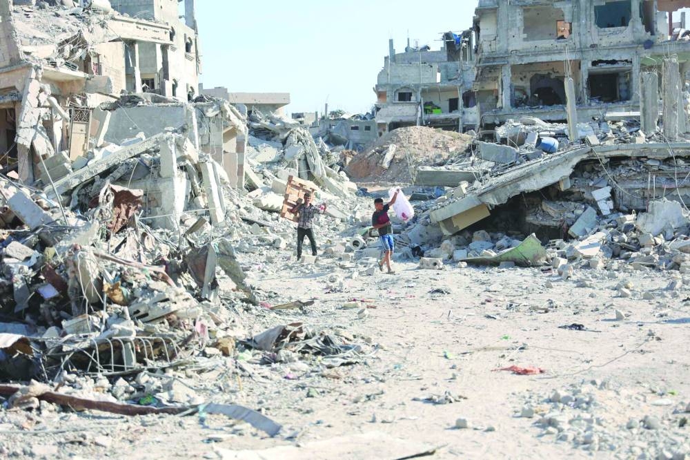 Palestinians salvage wood to use for cooking from the rubble of collapsed buildings in the Shujaiya neighbourhood, east of Gaza City yesterday