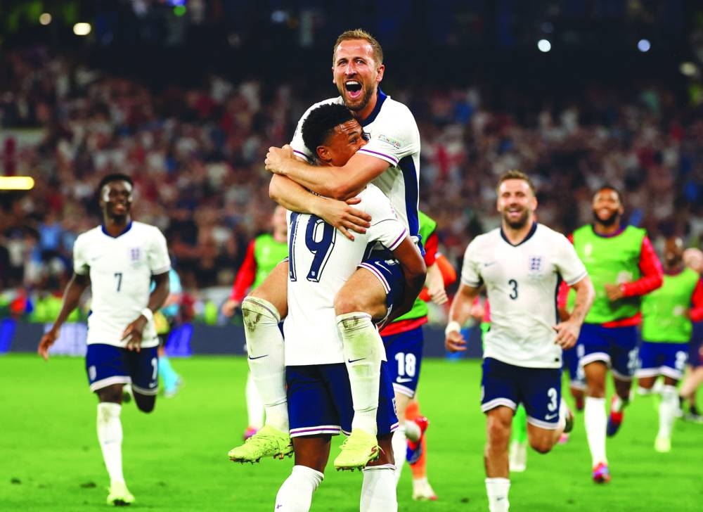 England’s Harry Kane celebrates with Ollie Watkins after winning the match on Wednesday. (Reuters)