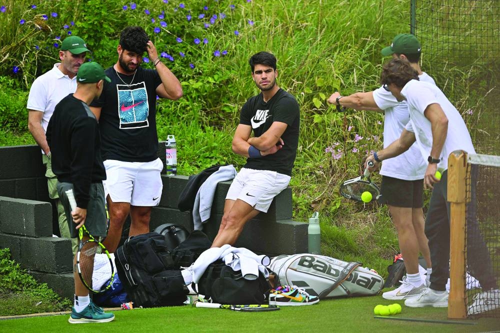 Spain’s Carlos Alcaraz (centre) takes part in a session on the Aorangi practice courts on the 11th day of the 2024 Wimbledon Championships in London on Thursday. (AFP)