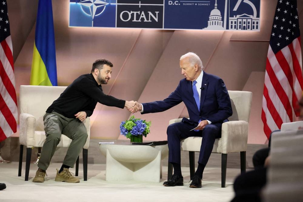 Ukraine's President Volodymyr Zelensky shakes hands with US President Joe Biden during a bilateral meeting in Washington yesterday. (Reuters)