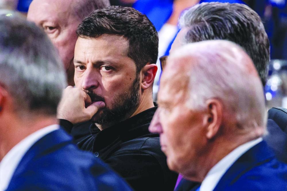 
Ukrainian President Volodymyr Zelensky (centre), with US President Joe Biden (right), during a meeting of the Nato-Ukraine Council at the Walter E Washington Convention Center in Washington, DC, on Thursday. Right: The Ukrainian president walks with French counterpart Emmanuel Macron through the Walter E Washington Convention Center during the summit in Washington, DC. (AFP) 