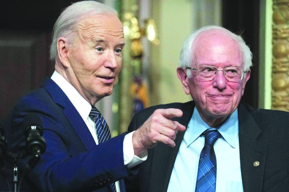 This picture taken in April 3 shows Biden with Sanders during an event about lowering healthcare costs in the Indian Treaty Room of the White House in Washington, DC. – AFP