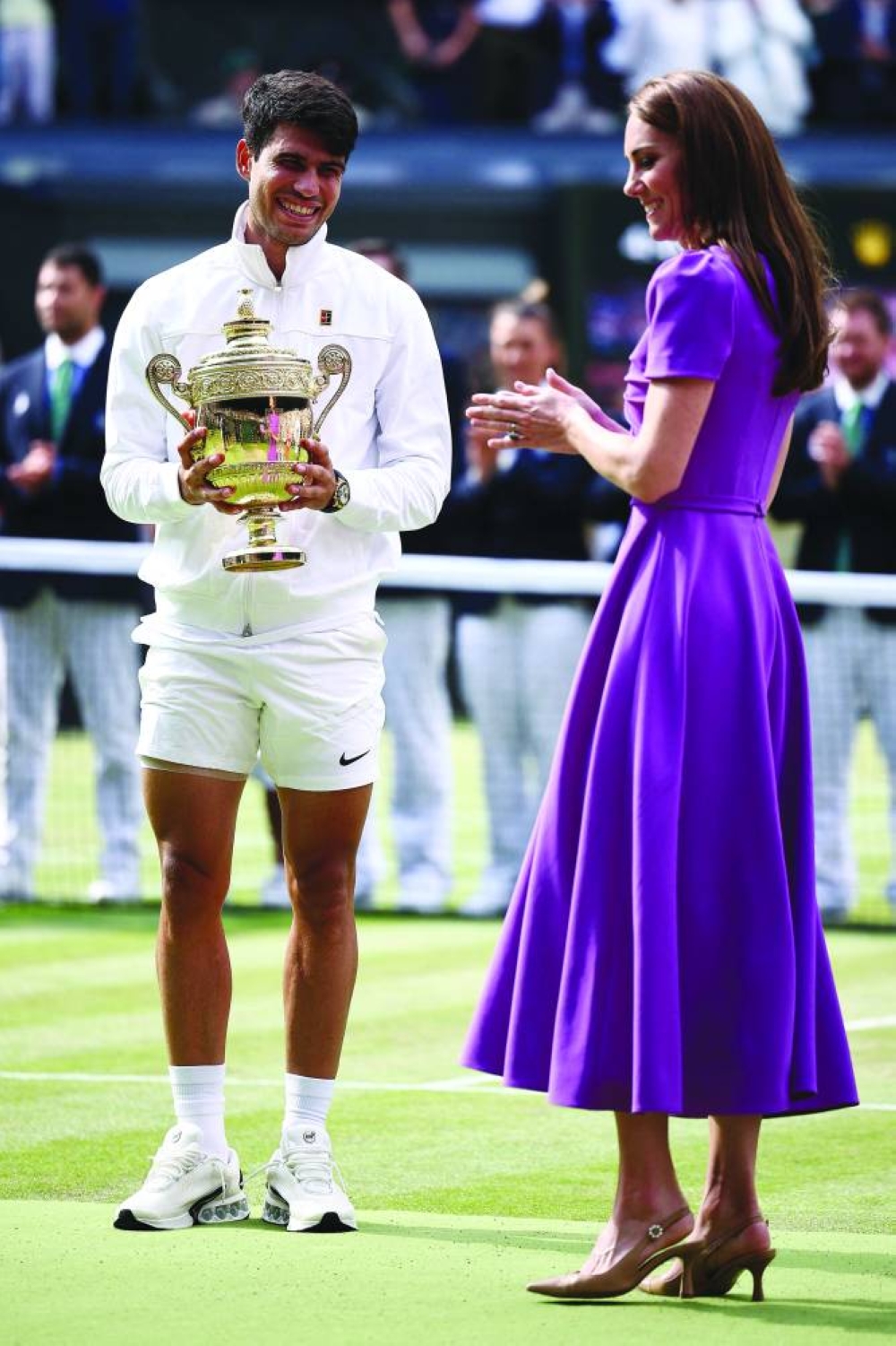 
Britain’s Catherine, Princess of Wales congratulates Spain’s Carlos Alcaraz as he receives the winner’s trophy after beating Serbia’s Novak Djokovic in Wimbledon final yesterday. (AFP) 
