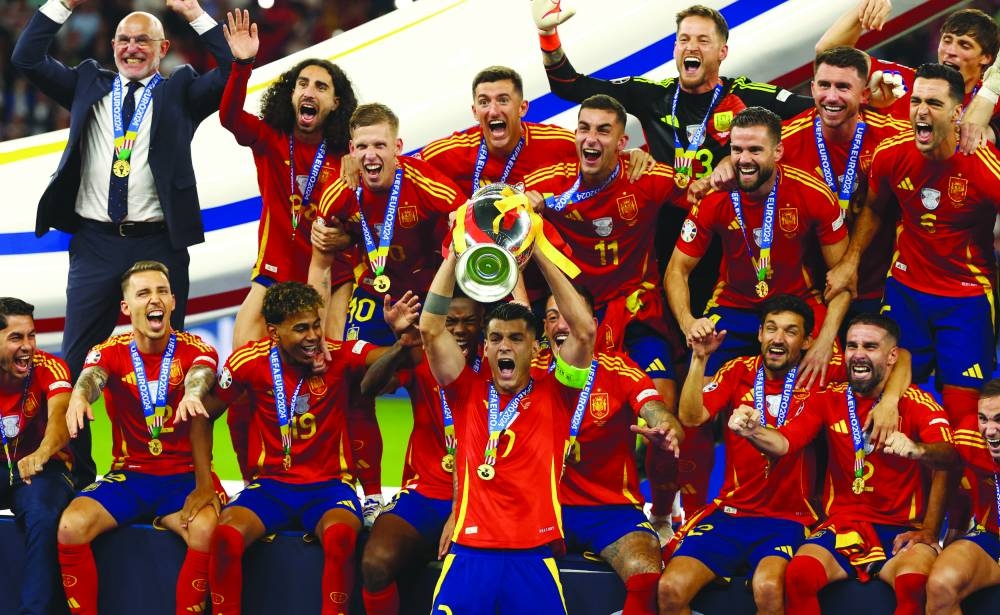 
Spain players celebrate with the trophy after winning the Euro 2024 final against England in Berlin yesterday. (Reuters) 