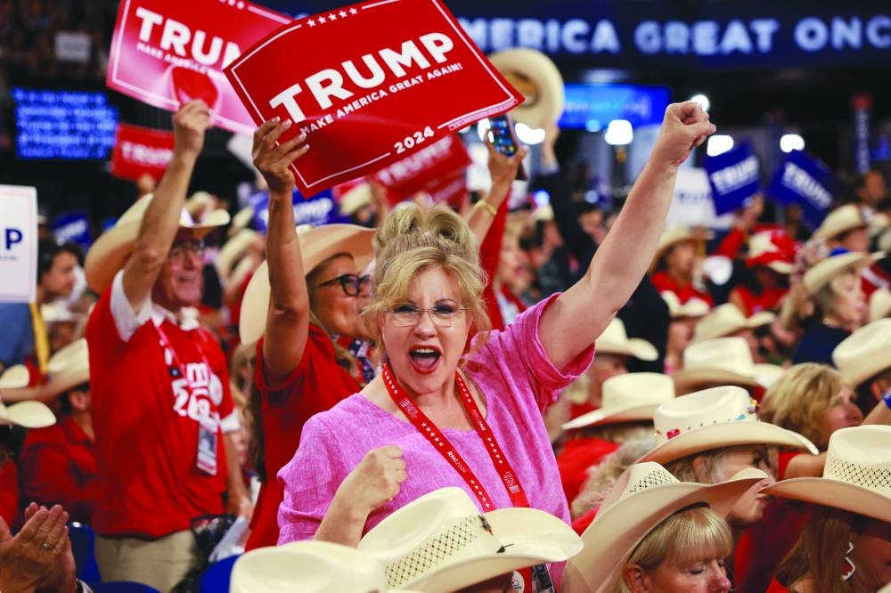 
People hold signs endorsing Republican presidential candidate, former US President Donald Trump on the first day of the Republican National Convention at the Fiserv Forum in Milwaukee, Wisconsin, yesterday. 