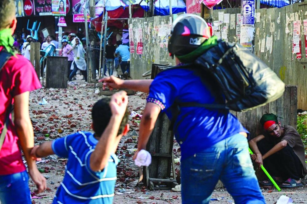 Anti-quota protesters and students backing the ruling Awami League party clash in Dhaka yesterday.