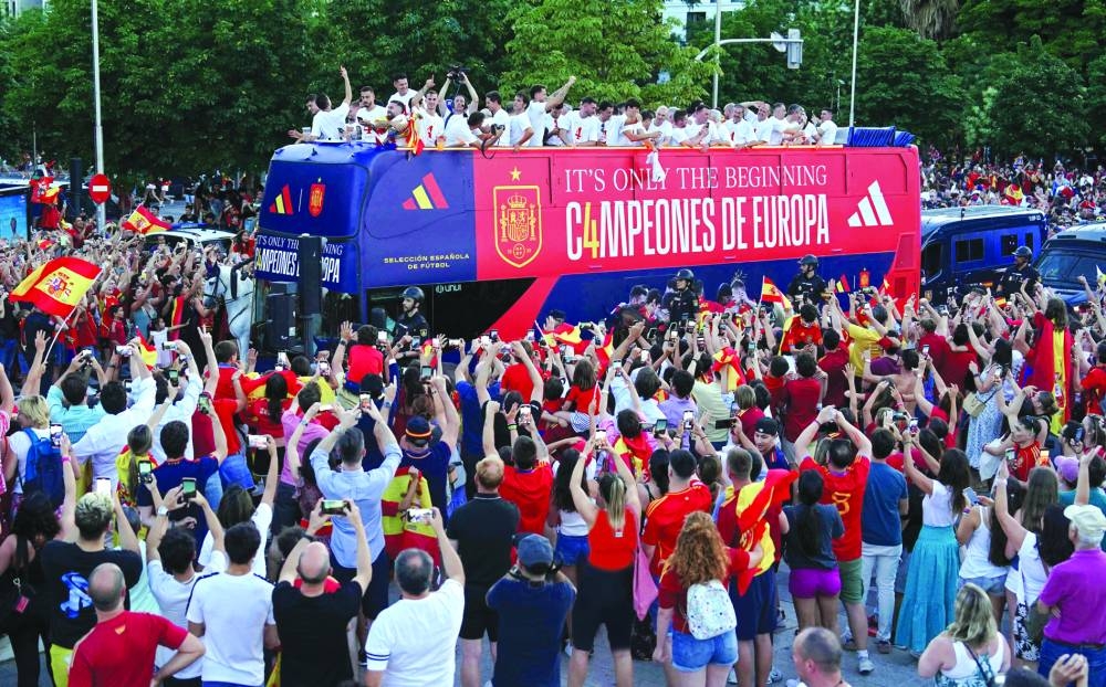 Spanish national football team players parade on board of a bus as Spain fans gather to celebrate after Spain won the UEFA Euro 2024 final against England. (AFP)