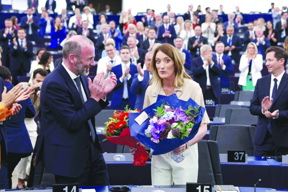
Roberta Metsola holds a floral bouquet while the parliament applauds her after being elected during the first plenary session of the newly-elected European Assembly in Strasbourg yesterday. (AFP) 