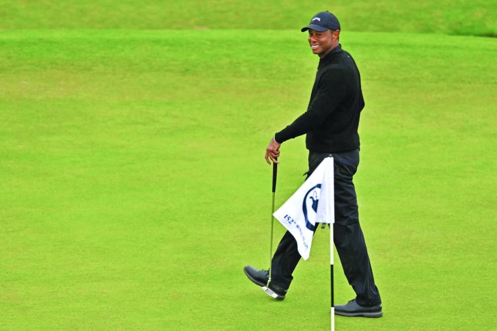 US golfer Tiger Woods smiles on the 18th green during a practice round on Wednesday ahead of the 152nd British Open Golf Championship at Royal Troon on the south west coast of Scotland. (AFP) 