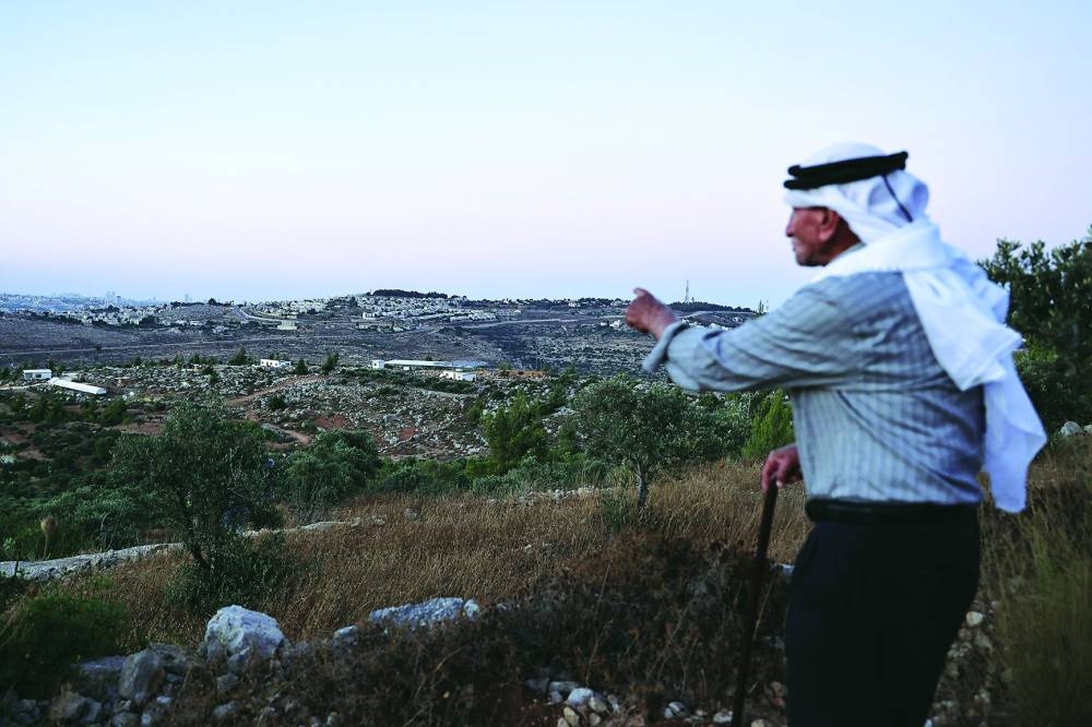 
Olayan Olayan, who was born in the village of Battir in 1941, overlooks a valley in which a new Israeli settlers outpost is built, as pictured from Battir. 
