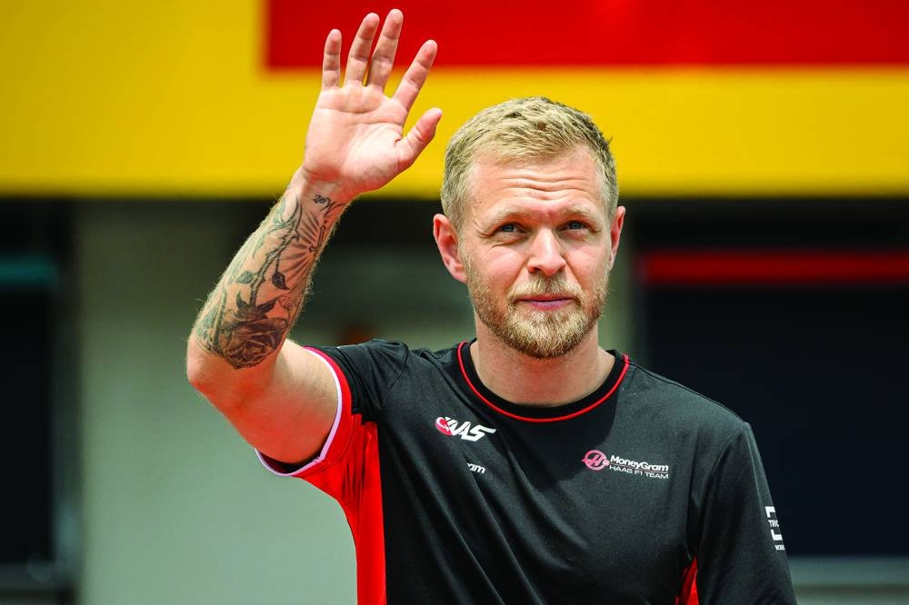 Haas F1's Danish driver Kevin Magnussen waves as he arrives to attend the Drivers Parade ahead of the Formula One Austrian Grand Prix on the Red Bull Ring race track in Spielberg, Austria, on June 30, 2024. Danish Formula One driver Kevin Magnussen will leave Haas at the end of the current season, the US constructor announced on July 18, 2024 ahead of the Hungarian Grand Prix. (Photo by Jure Makovec / AFP)