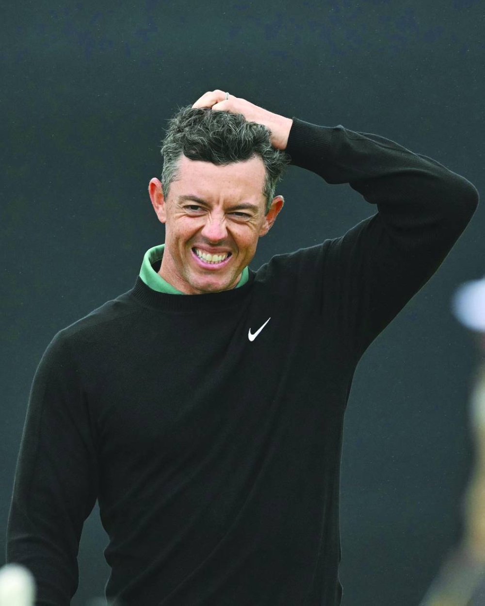 Northern Ireland’s Rory McIlroy reacts after making a bogey on the 18th green on Thursday. (AFP)