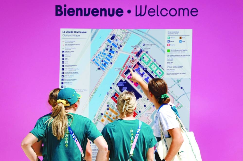 
Australia team members look at the map of the athletes’ village for the Paris 2024 Olympics and Paralympics game in Saint-Denis yesterday, ahead of the opening ceremony. (AFP) 