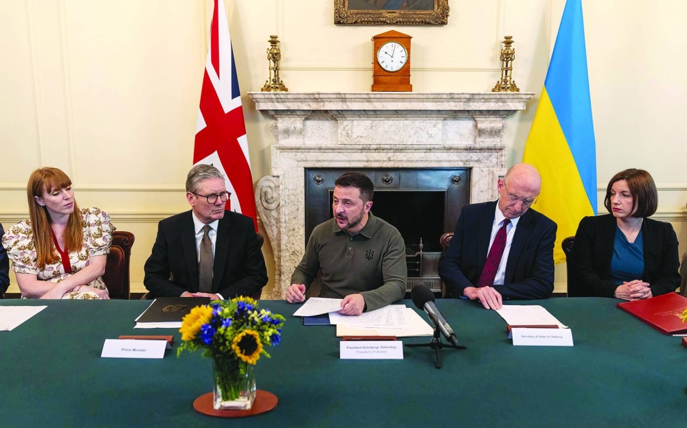 Ukraine's President Volodymyr Zelensky (C), sitting between Britain's Deputy Prime Minister and Levelling Up, Housing and Communities Secretary Angela Rayner (L), Britain's Prime Minister Keir Starmer (2L) and Britain's Defence Secretary John Healey, addresses Cabinet Ministers during an extraordinary meeting of the Cabinet at 10 Downing Street in central London on July 19, 2024. Ukrainian President Volodymyr Zelensky addressed the UK's new Cabinet on Friday, briefing senior ministers about the battlefield situation in the war with Russia, Downing Street said. (Photo by Richard Pohle / POOL / AFP)
