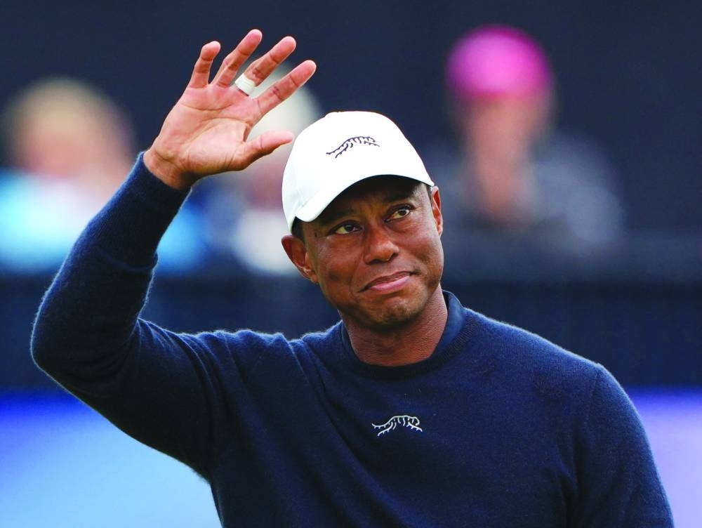 Tiger Woods acknowledges the crowd after finishing his second round on Friday, (Reuters)