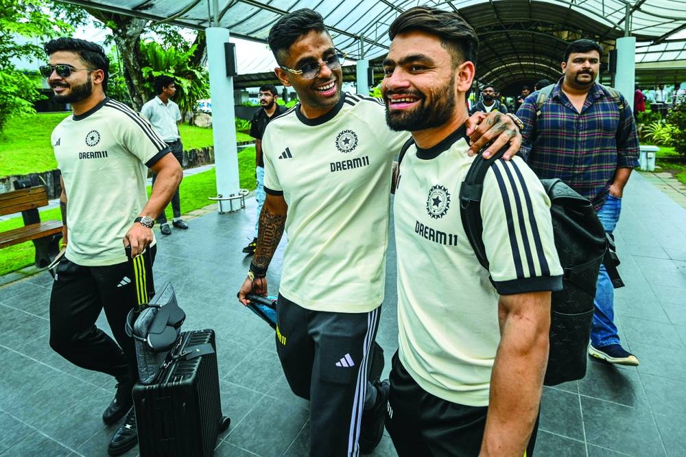 
India’s players Suryakumar Yadav (second from left), Rinku Singh (right) and Riyan Parag (left) arrive at the Bandaranaike International Airport in Colombo. (AFP) 