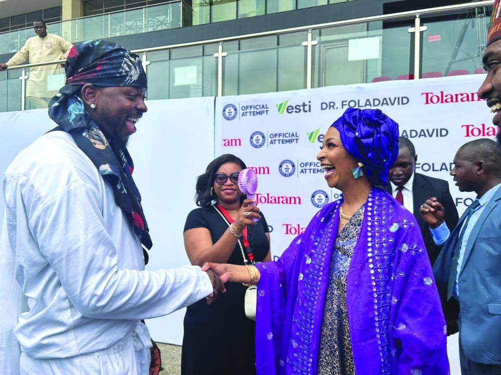 Hannatu Musa Musawa, Minister of Art, Culture, and Creative Economy shakes hands with Fola David in Lagos.