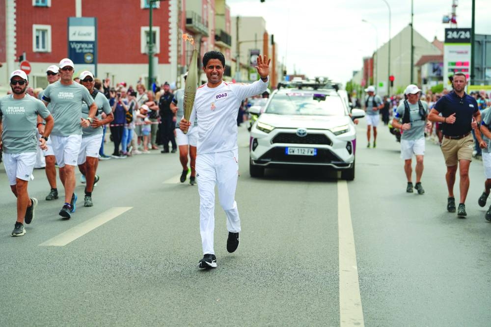 Nasser al-Khelaifi carried the Olympic flame through the streets of Vigneux (Essonne), suburbs of Paris in France, on Monday.