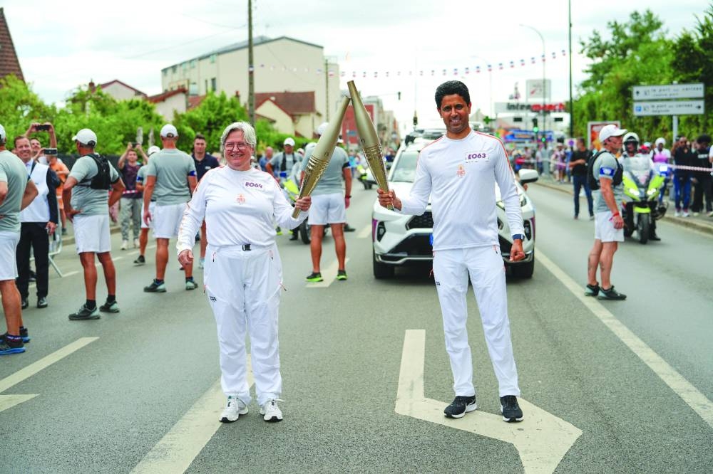 Accompanied by numerous Parisian supporters, football club Paris Saint-Germain’s (PSG) Nasser al-Khelaifi carried the Olympic flame through the streets of Vigneux (Essonne), suburbs of Paris in France, on Monday.