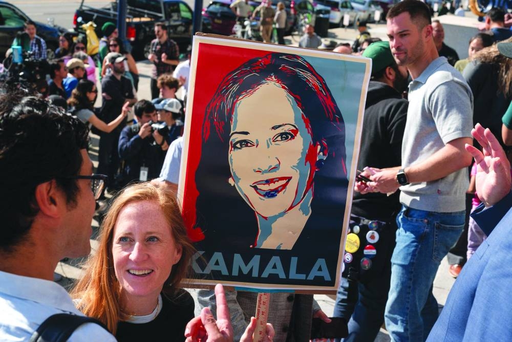
A supporter holds a sign as members of the San Francisco Democratic Party rally in support of Kamala Harris, at City Hall in San Francisco, California yesterday. 