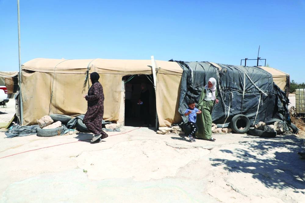 
Palestinian women walk outside a Doctors Without Borders (MSF) charity tent clinic in Susya village, in the south of the occupied West Bank. 