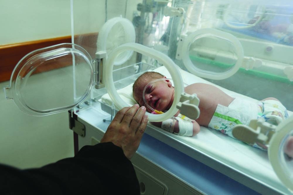 Palestinian baby Malek Yassin, who was saved from the womb of his mother Ola al-Kurd, who was killed in an Israeli strike, amid the ongoing Israel-Hamas conflict, lies in an incubator at a hospital in central Gaza Strip.