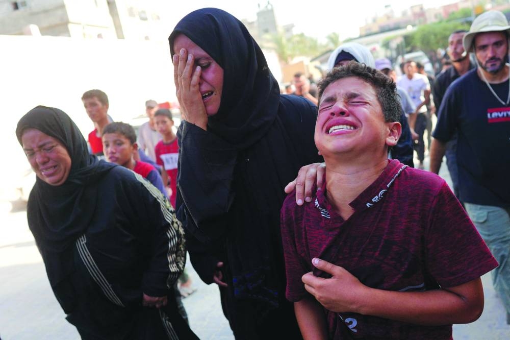 
A distressed Palestinian woman and boy arrive at the Nasser hospital after Israeli forces targeted the northeastern district of Khan Younis, in the southern Gaza Strip, yesterday. 