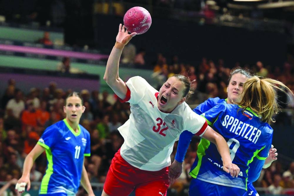 Denmark’s Mie Hoejlund (centre) attempts to score during the preliminary round Group A handball match against Slovenia at the Paris Olympic Games on Thursday. (AFP) 