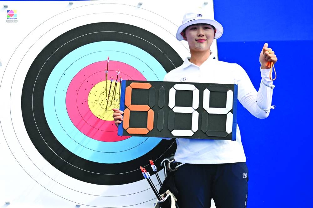 South Korea’s Lim Si-hyeon poses after breaking the world record in archery preliminary round in Paris. (AFP) 