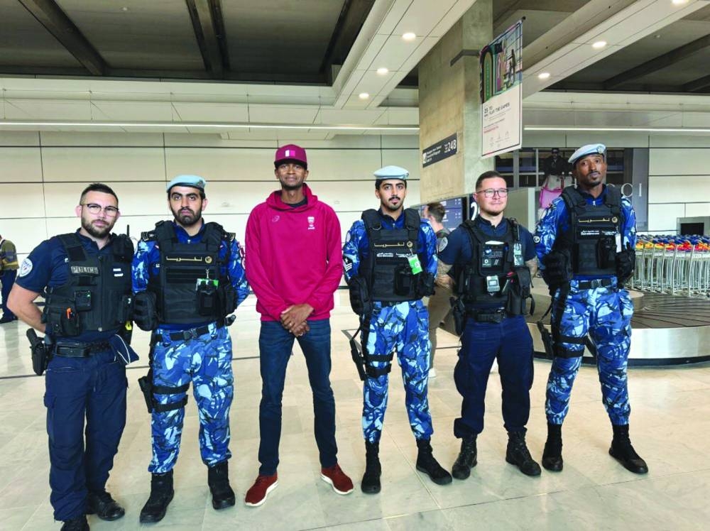 
Qatar’s Olympic high jump defending champion Mutaz Barshim poses with members of the Qatari Security Forces on his arrival in Paris for the Olympics Games yesterday. Qatari security forces, equipped with armoured vehicles and urban camouflage livery, are at the French capital to help secure the global event. 