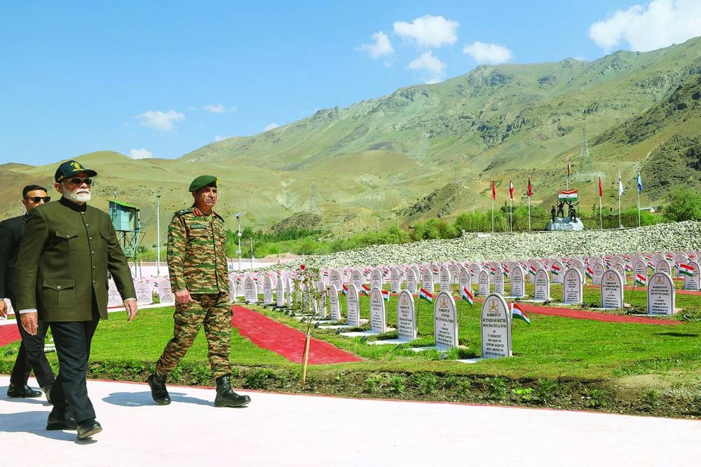 India’s Prime Minister Narendra Modi (centre) attends a ceremony to pay homage to soldiers who were martyred during the 1999 war on the occasion of Kargil Vijay Diwas at Kargil War Memorial in Drass. 